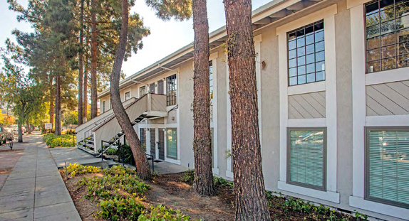Exterior walkway along two-story building with exterior stairway