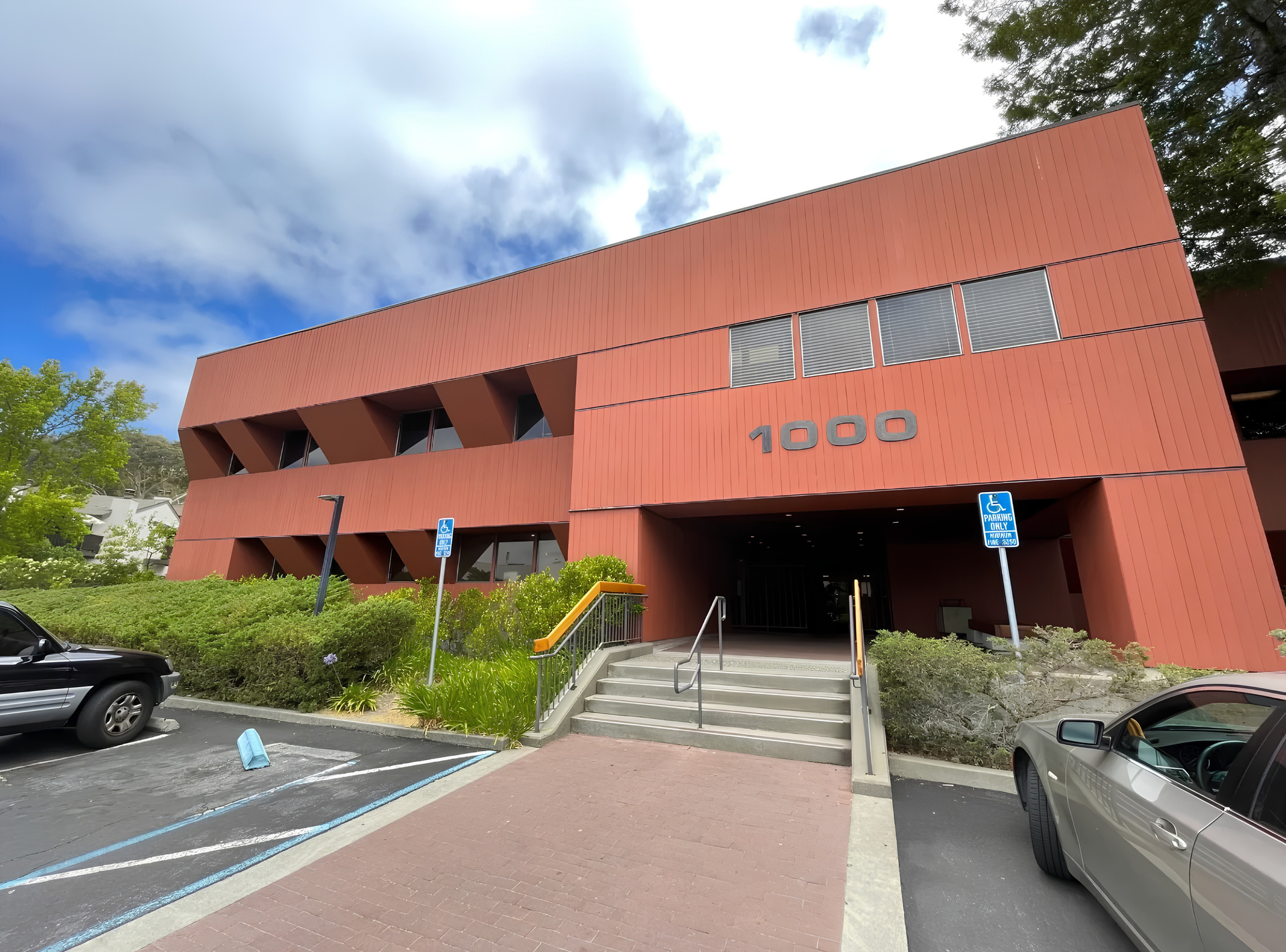 Building entrance with address numerals and stepped walkway